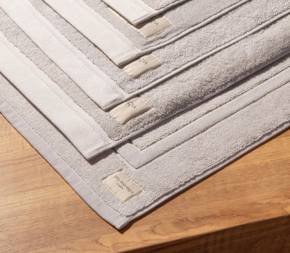 Set of bath mats with textured surface on a wooden floor