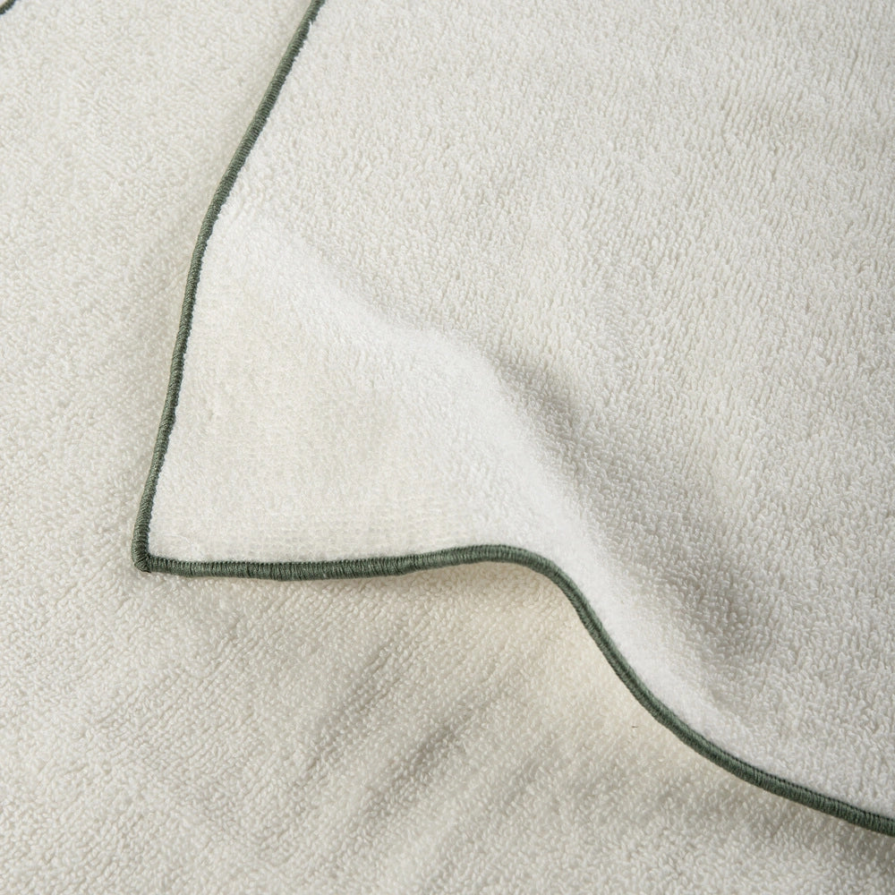 Close-up of a textured fabric with a green border