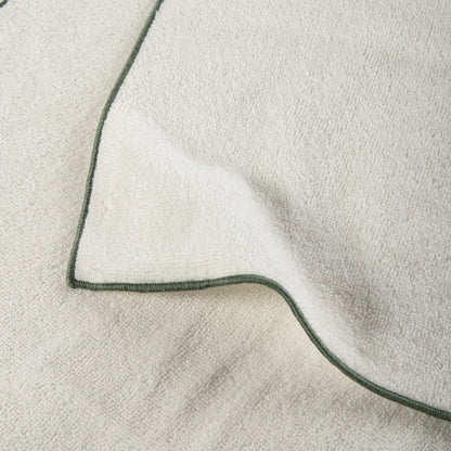 Close-up of a textured fabric with a green border