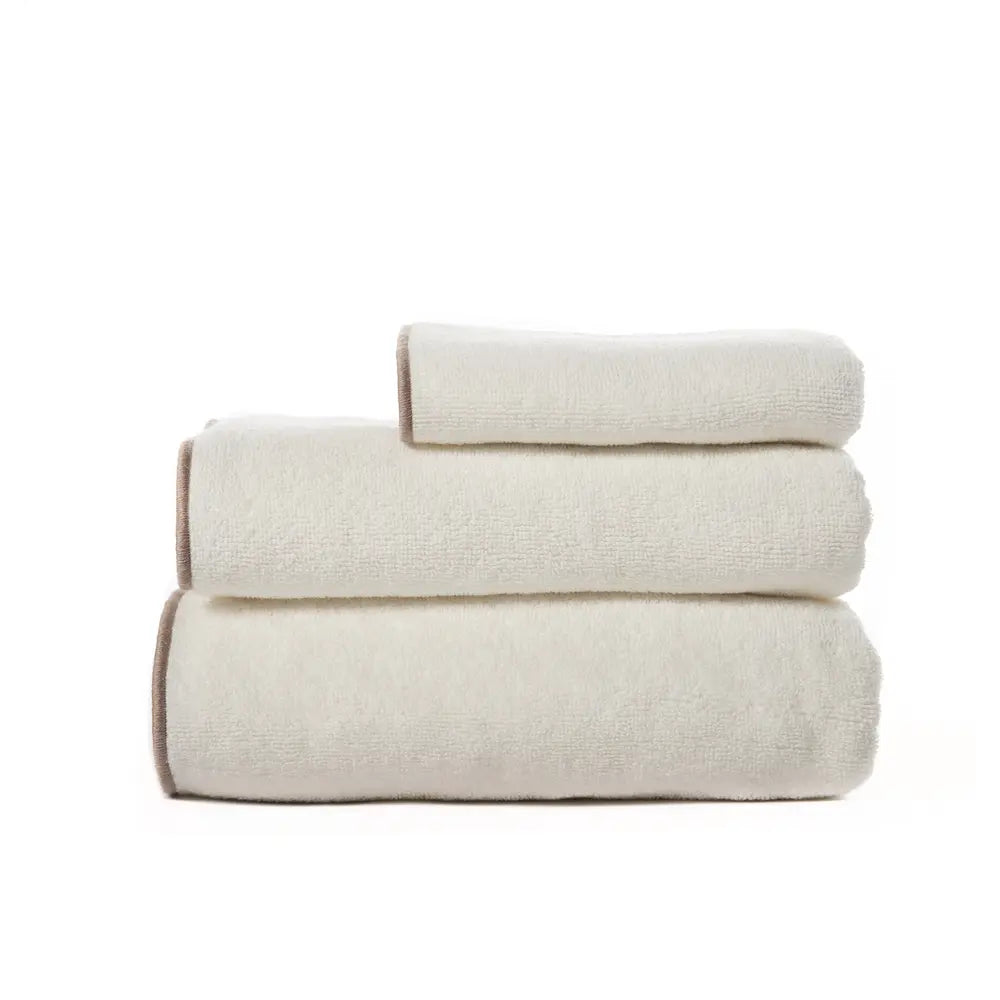 A neat stack of freshly folded white towels.