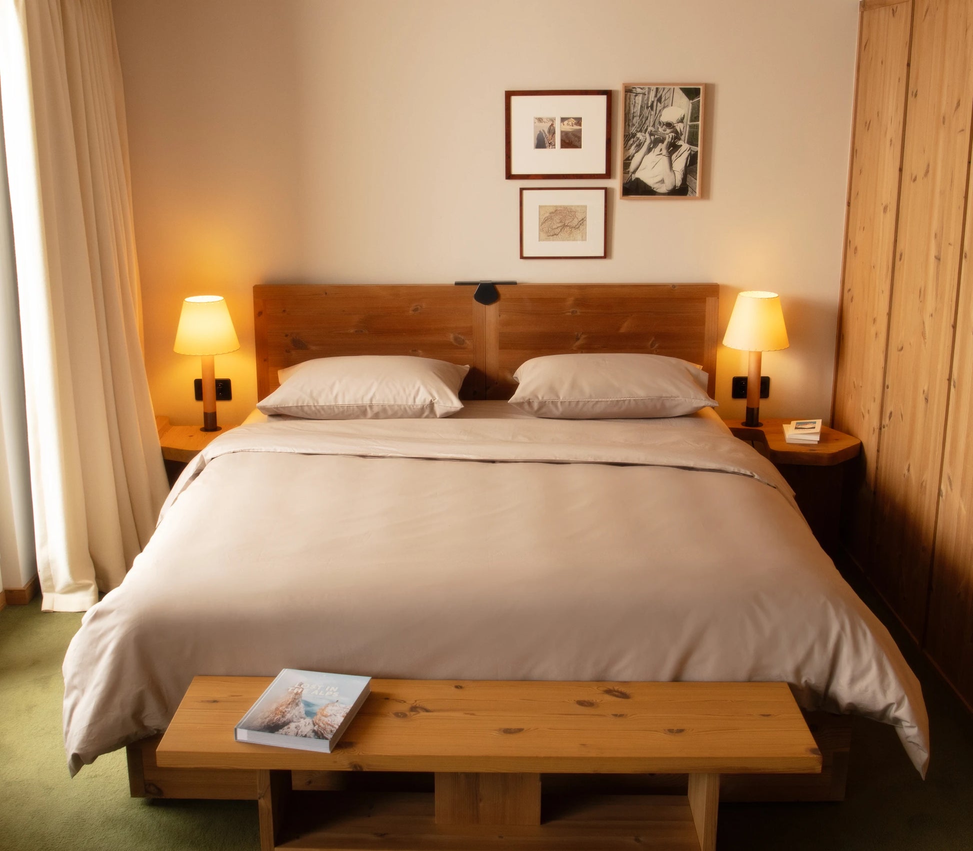 Bedroom with wooden bed, nightstands, and lamps.