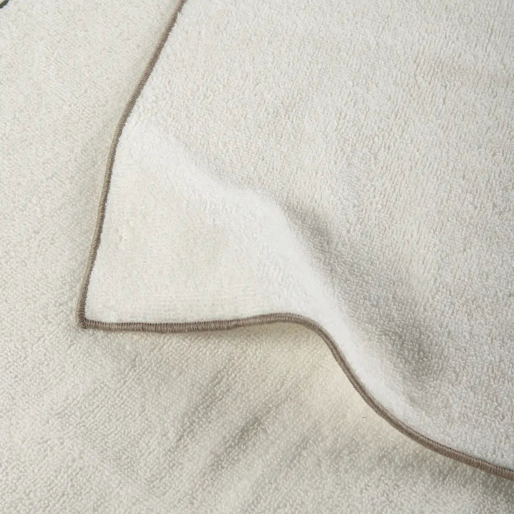 Close-up of a textured fabric with a brown border